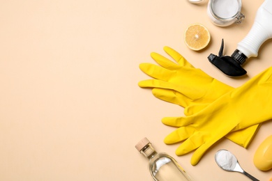 Flat lay composition with vinegar and cleaning supplies on color background. Space for text