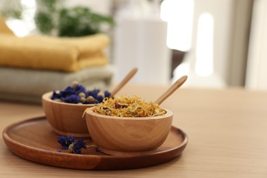 Photo of Dry flowers on wooden table indoors, space for text. Spa time