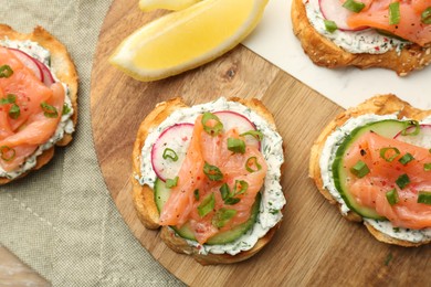 Tasty canapes with salmon served on table, top view