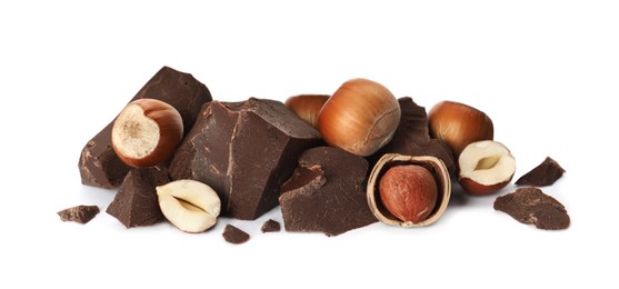 Photo of Delicious chocolate chunks and hazelnuts on white background