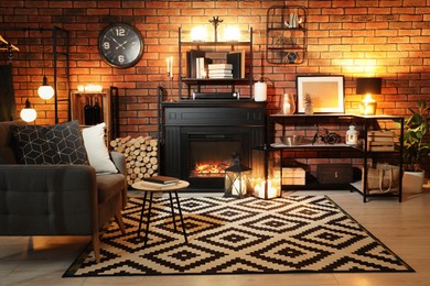 Photo of Stylish living room with beautiful fireplace, armchair and different decor at night. Interior design