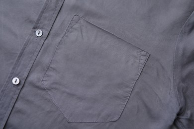 Gray shirt with pocket as background, top view