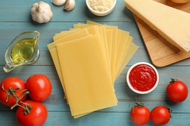 Ingredients for lasagna on blue wooden table, flat lay