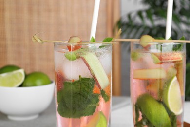 Tasty rhubarb cocktail with lime indoors, closeup