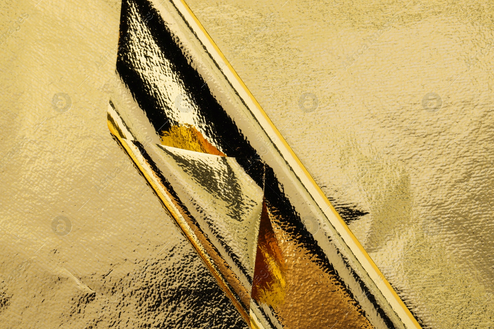 Edible gold leaf sheets as background, top view Photo of Edible gold leaf sheets as background, top view