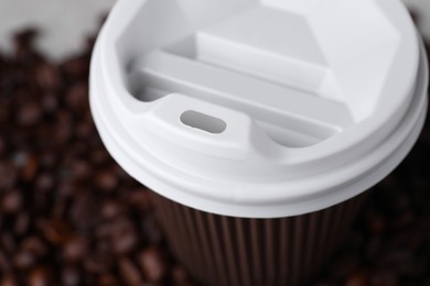 Photo of Coffee to go. Paper cup on table, closeup