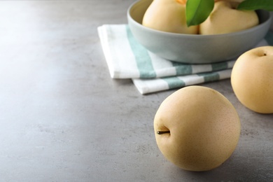 Photo of Fresh apple pears on grey table, space for text