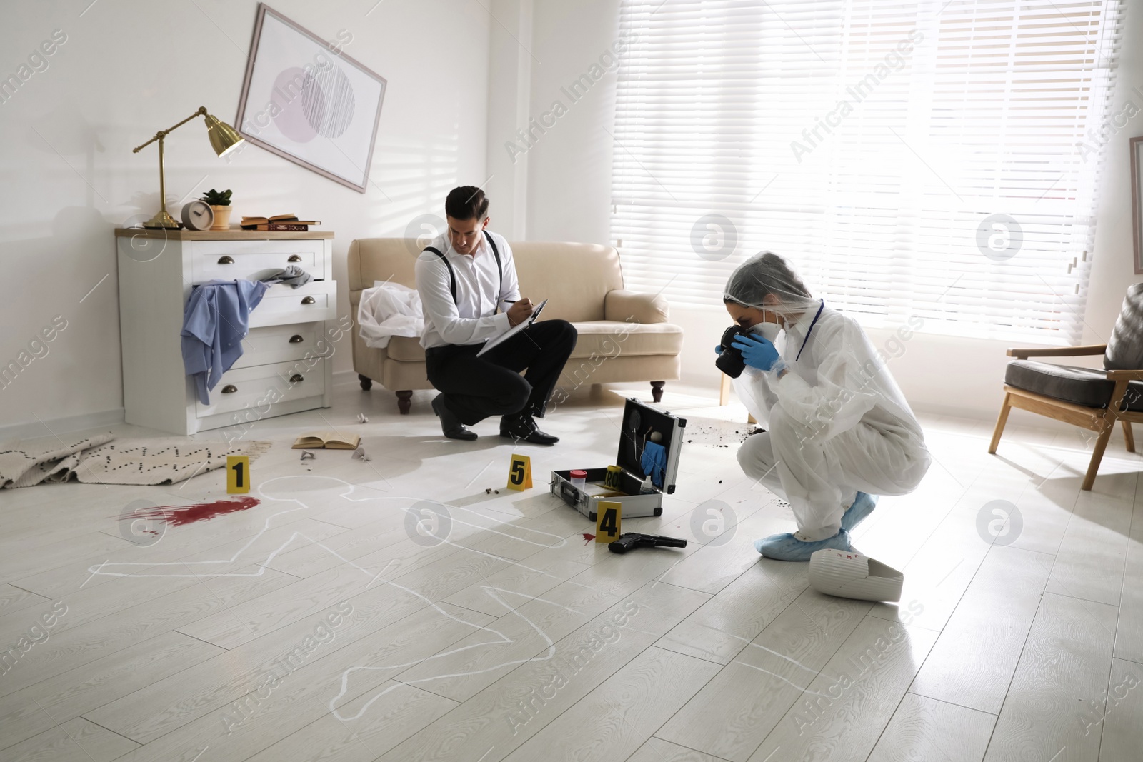 Photo of Investigators working at crime scene in living room