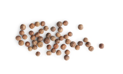 Photo of Allspice pepper grains on white background, top view. Natural spice