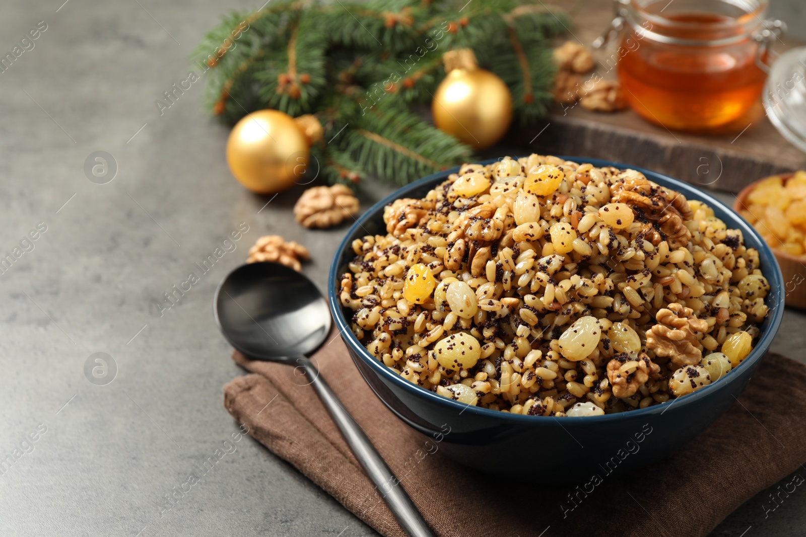 Photo of Traditional Christmas slavic dish kutia served on grey table, closeup. Space for text