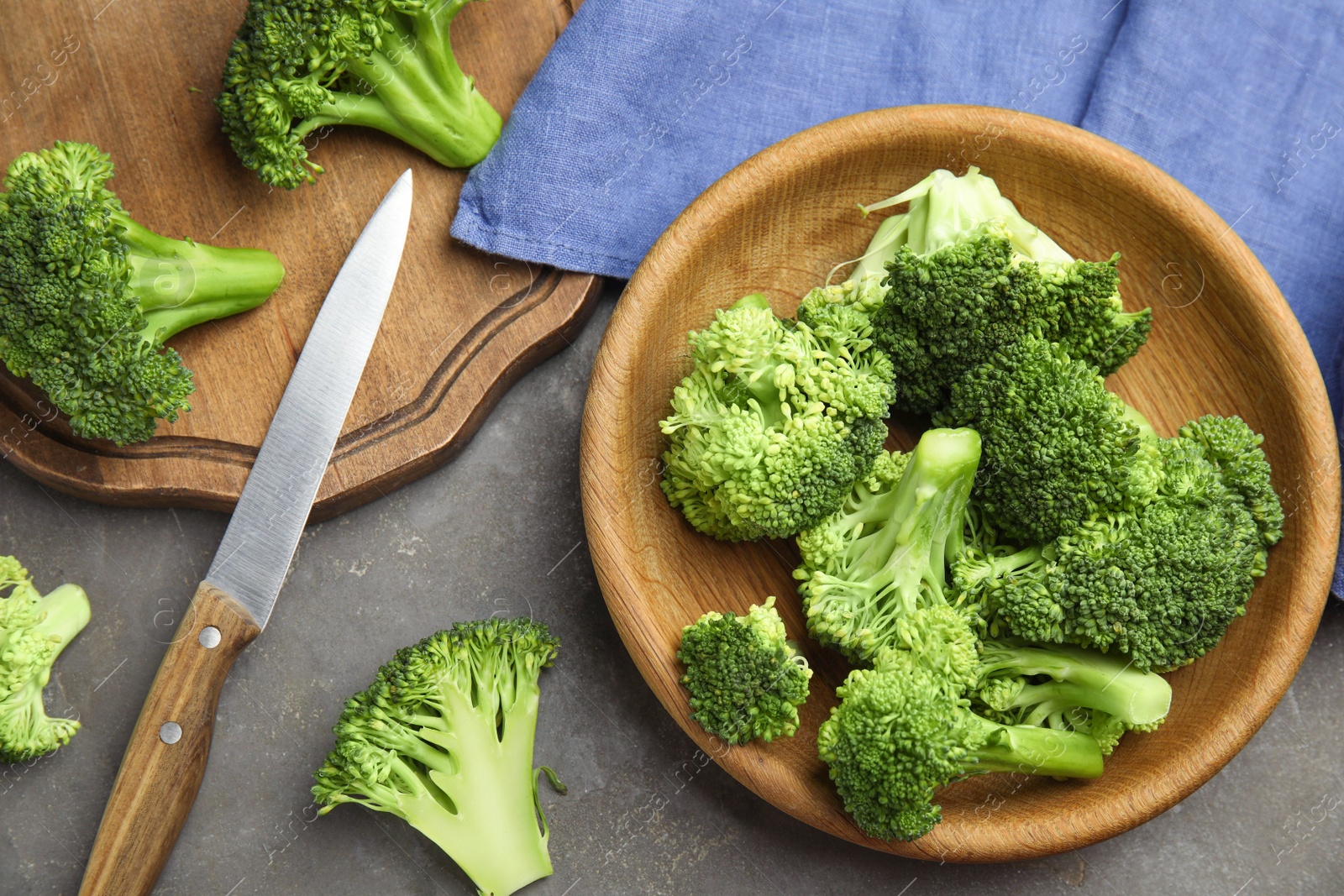 Photo of Fresh green broccoli on grey table, flat lay