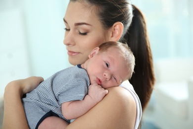 Young woman with her newborn baby at home