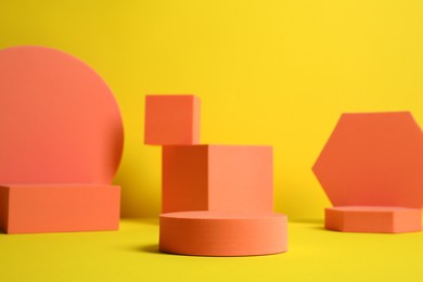 Many orange geometric figures on yellow background. Stylish presentation for product