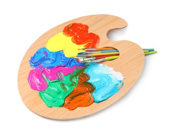 Photo of Palette with paints and brushes on white background, top view. Artist equipment