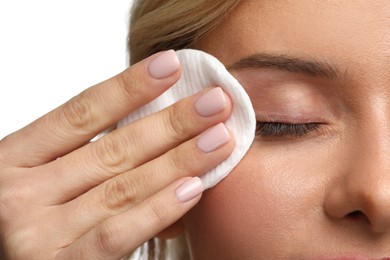 Photo of Woman removing makeup with cotton pad on white background, closeup