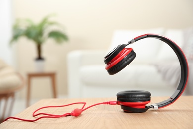 Photo of Stylish headphones on table indoors. Space for text