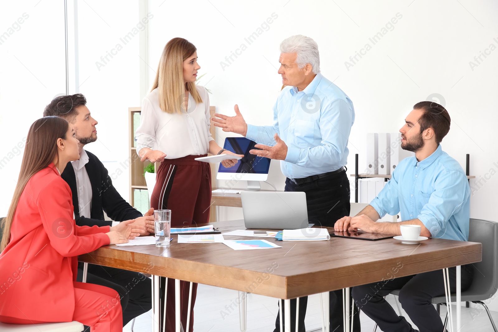 Photo of Office employees having argument during business meeting