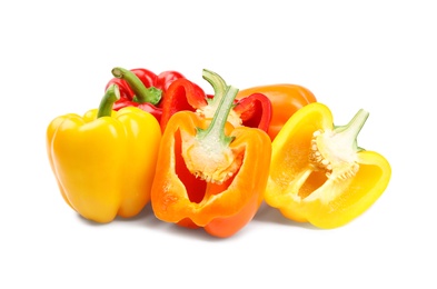 Whole and cut bell peppers on white background