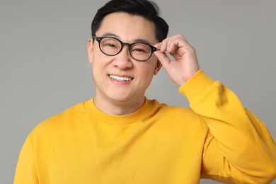 Portrait of happy man on grey background