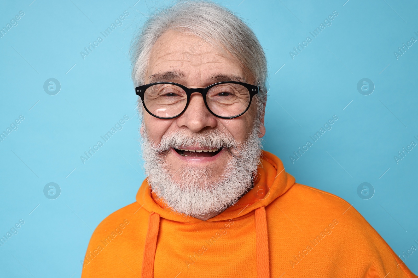 Photo of Senior man with mustache on light blue background