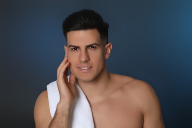 Handsome man after shaving on blue background