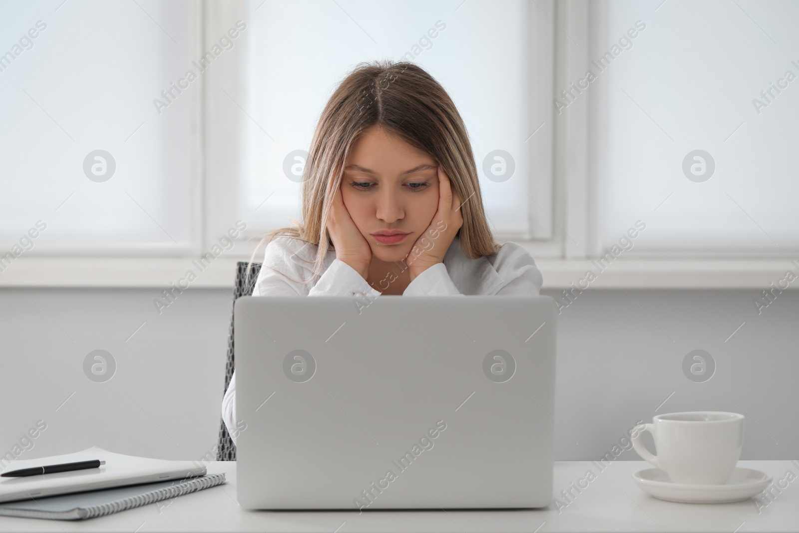 Photo of Sleepy young woman at workplace in office