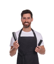 Photo of Smiling hairdresser with comb and brush on white background