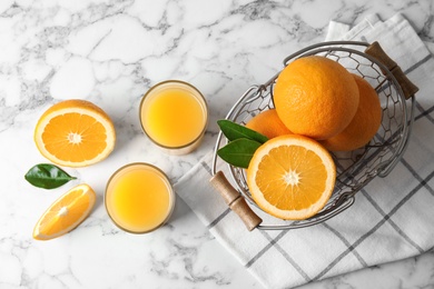 Flat lay composition with orange juice and fresh fruit on marble background