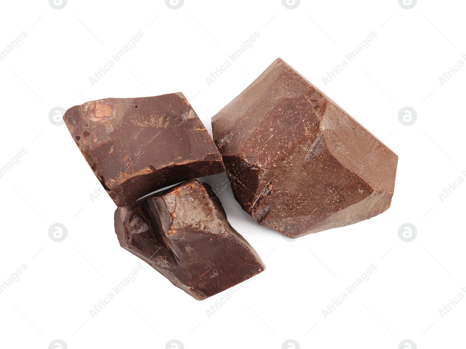 Photo of Pieces of tasty chocolate on white background, top view