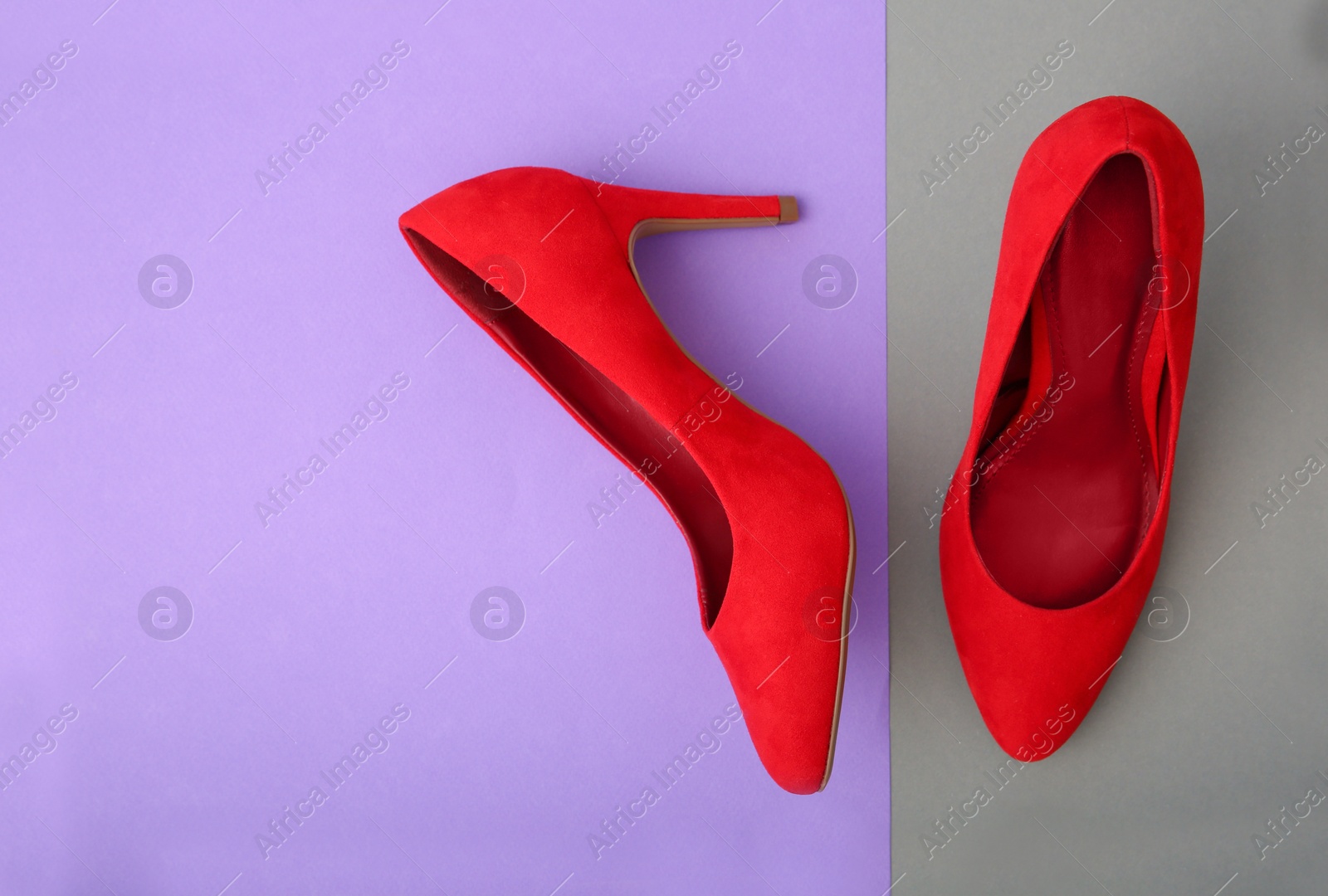 Photo of Pair of female shoes on color background