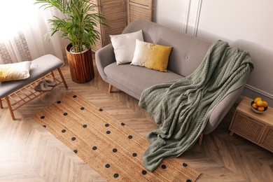 Living room interior with stylish rug and furniture, above view