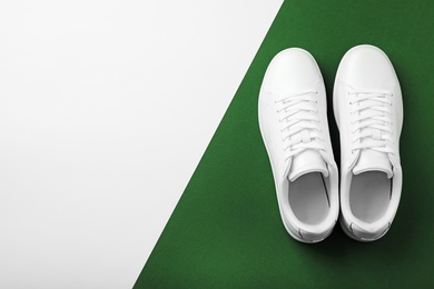 Photo of Pair of sneakers on color background, flat lay. Space for text