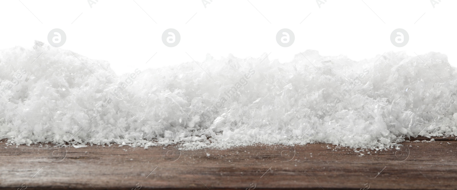 Photo of Snow on wooden surface against white background. Christmas season