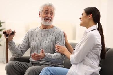 Photo of Health care and support. Nurse listening to elderly patient in hospital