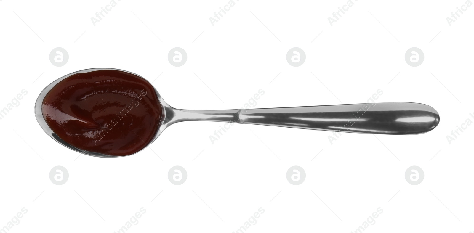 Photo of Tasty barbecue sauce in spoon isolated on white, top view