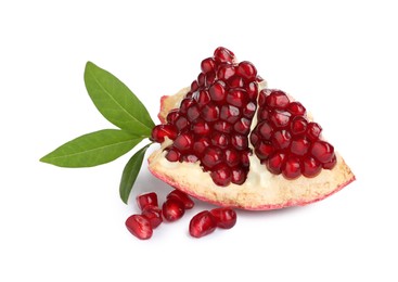 Photo of Piece of ripe juicy pomegranate and green leaves on white background