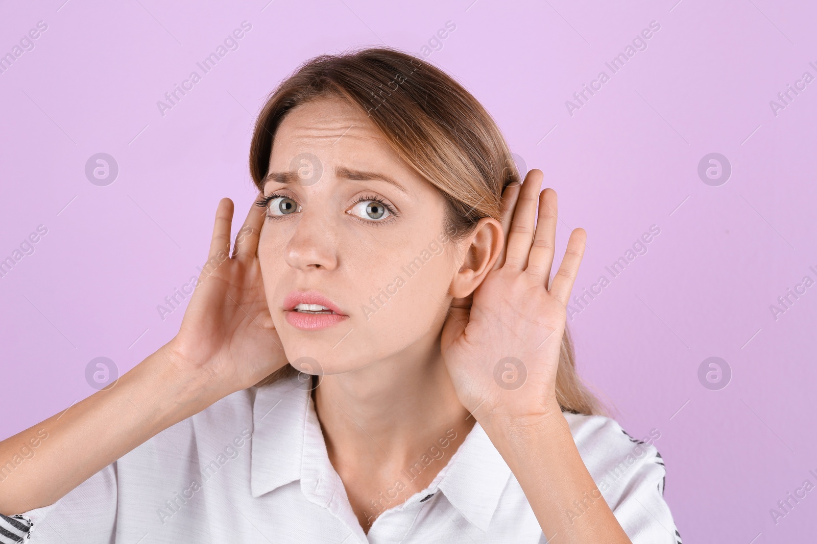 Photo of Young woman with hearing problem on color background