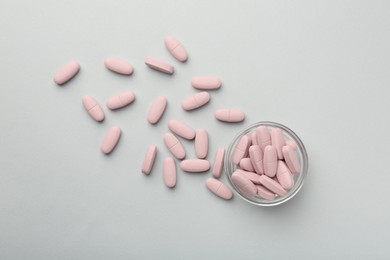 Photo of Vitamin pills on grey background, flat lay
