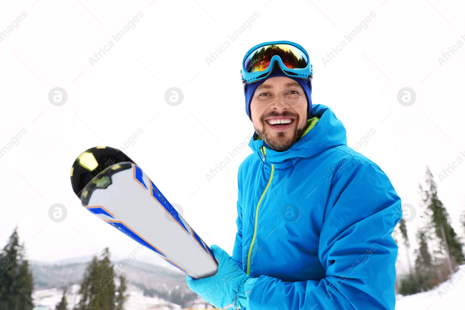 Photo of Male skier on slope at resort. Winter vacation