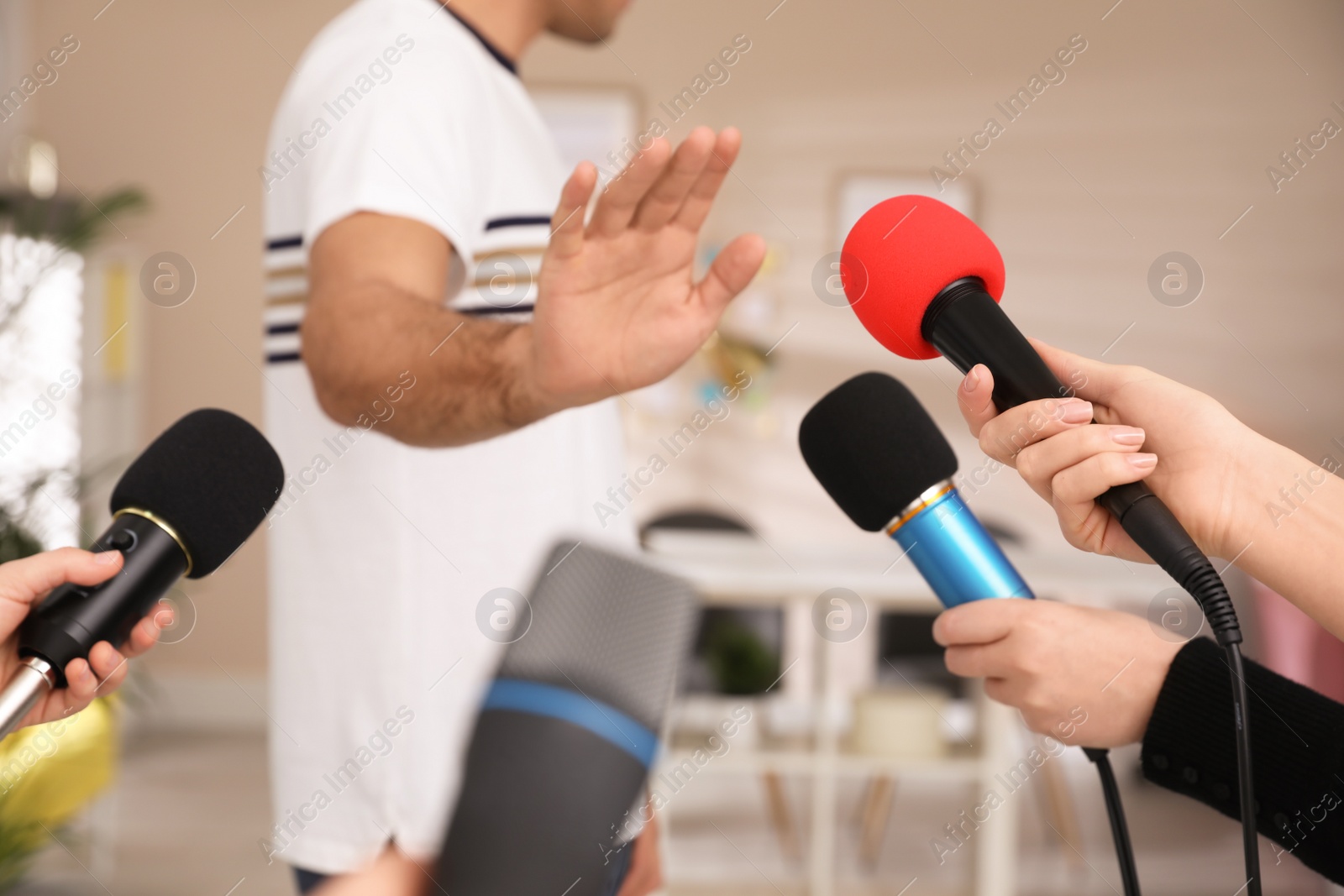 Photo of Man avoiding journalist's questions at interview indoors, closeup view