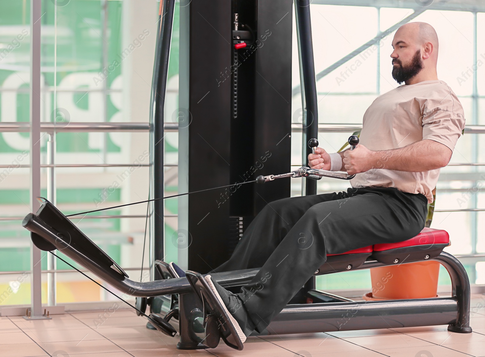 Photo of Overweight man training in gym