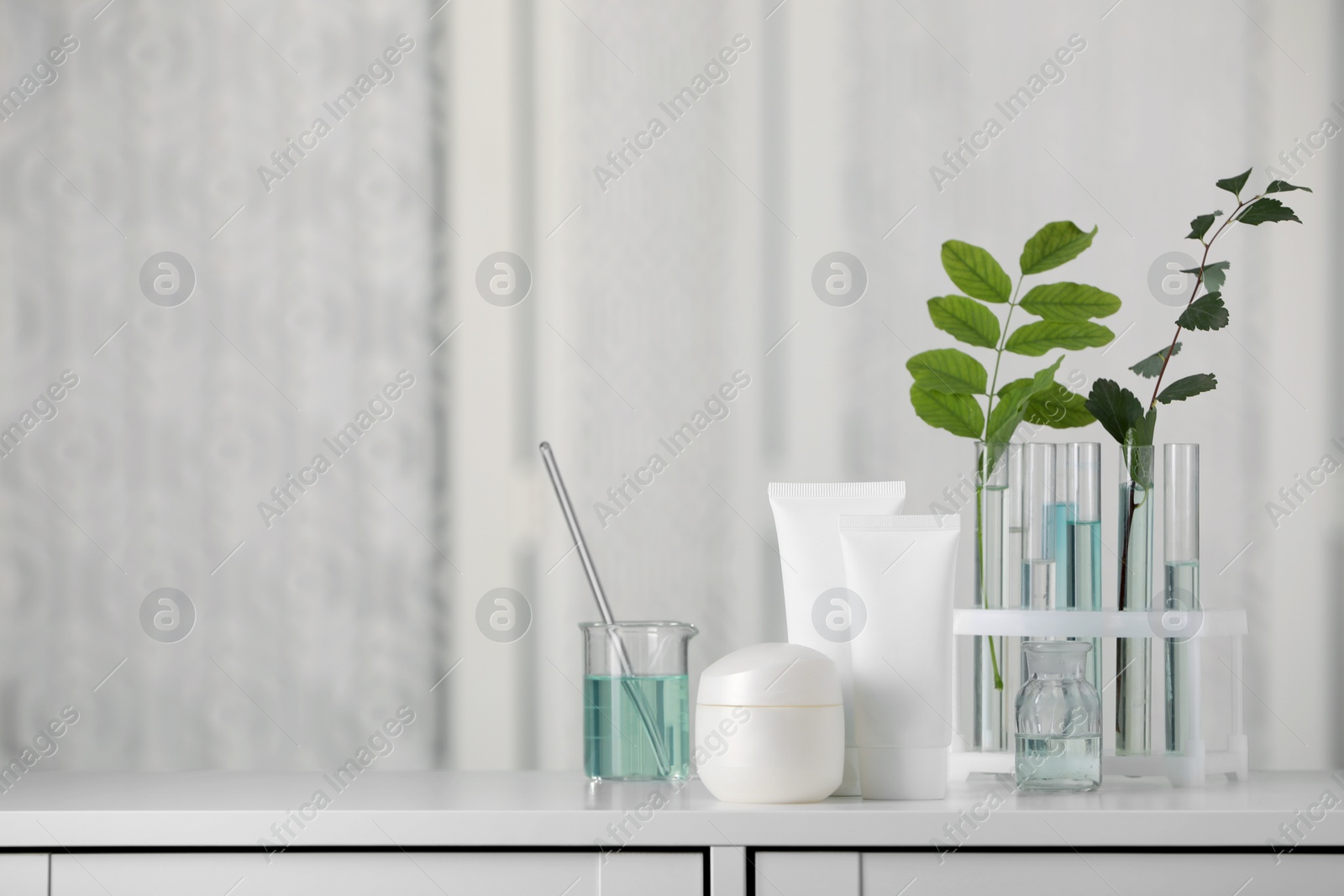 Photo of Many containers and glass tubes with leaves on white lab drawer indoors, space for text