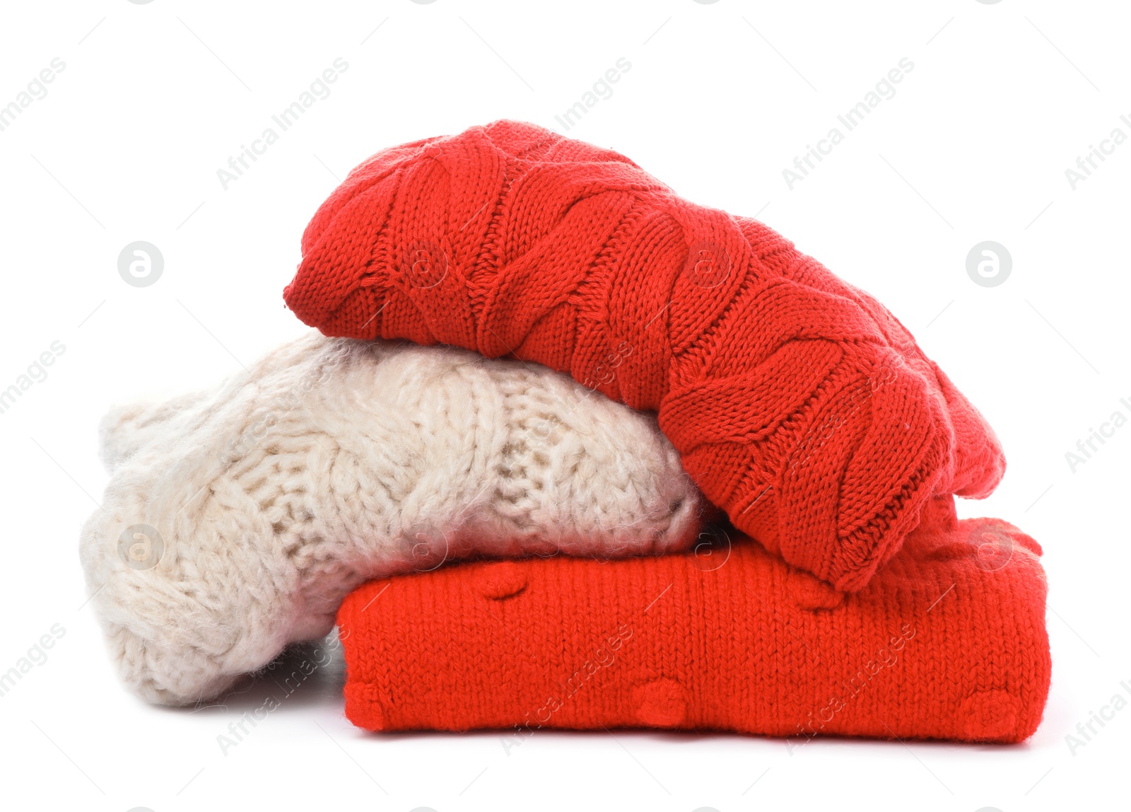 Photo of Stack of folded knitted sweaters on white background