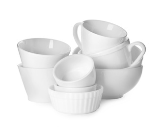 Photo of Clean bowls and cups on white background
