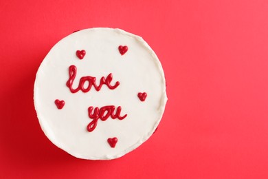 Photo of Bento cake with text Love You and space for text on red table, top view. St. Valentine's day surprise