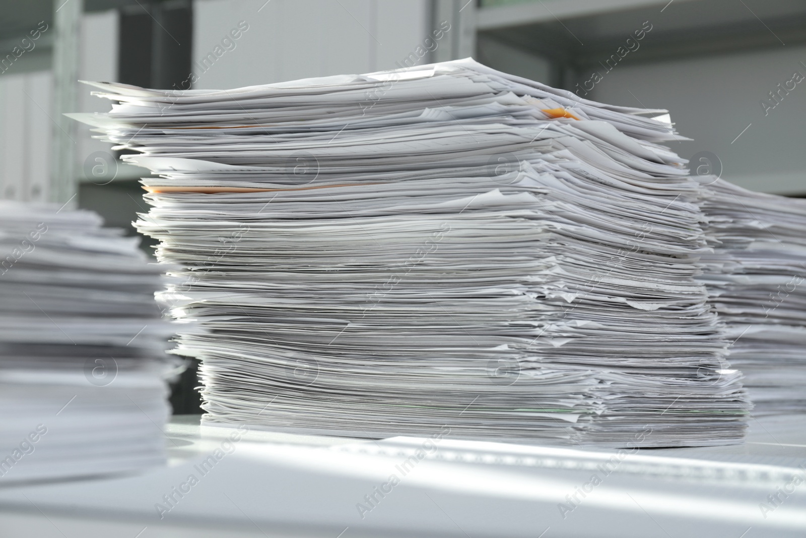 Photo of Stacks of documents on table in office