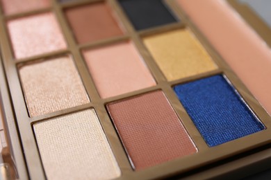 Photo of Beautiful eyeshadow palette as background, closeup. Professional cosmetic product