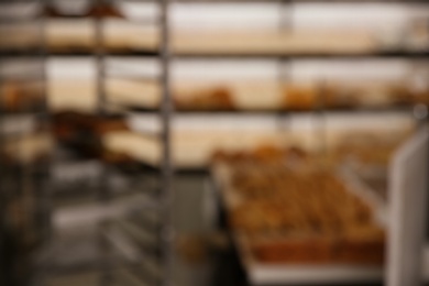 Blurred view of rack with pastries in workshop