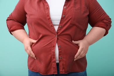 Overweight woman on color background