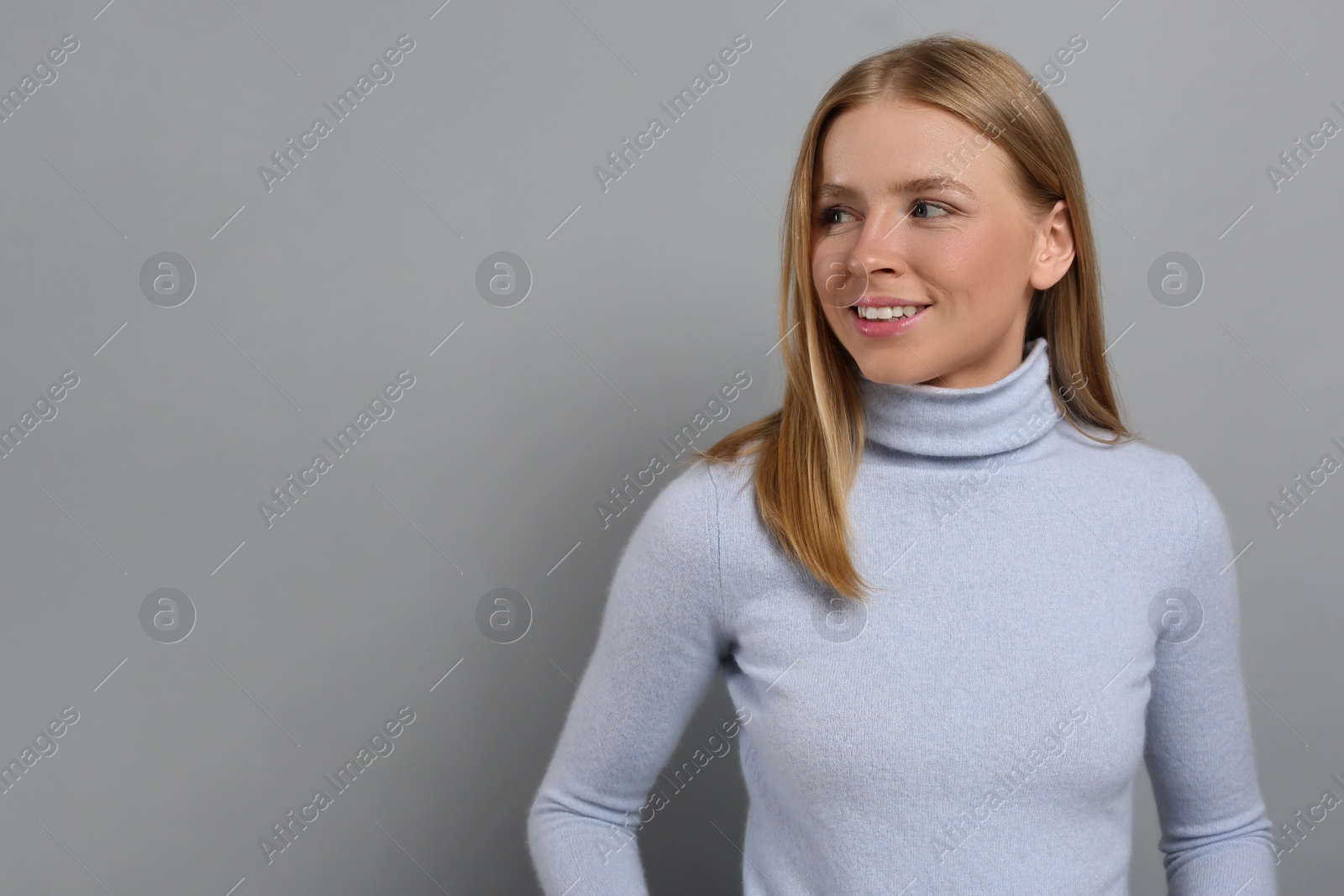 Photo of Portrait of beautiful young woman on grey background. Space for text